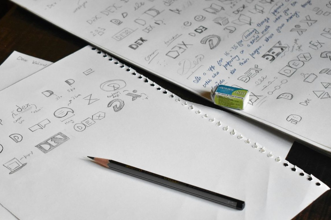 Sketchbook with early logo design concepts